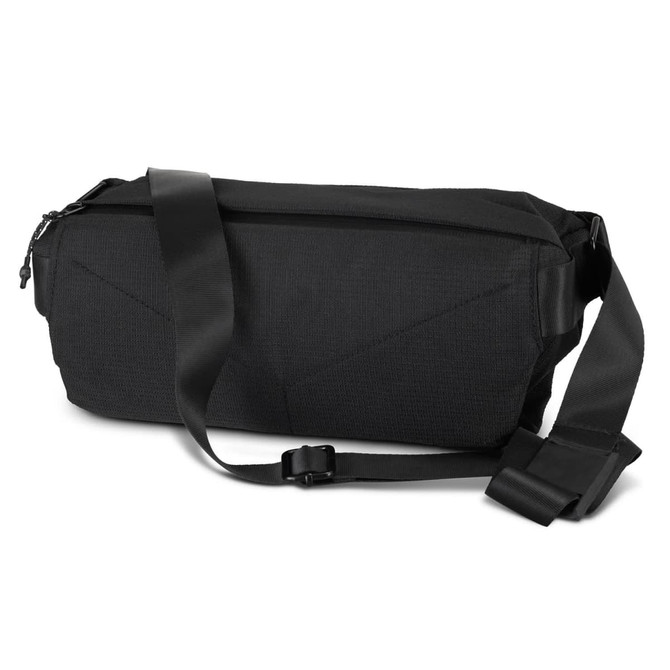 A black sling bag with a durable design and adjustable strap. It has a zip closure and features a logo.