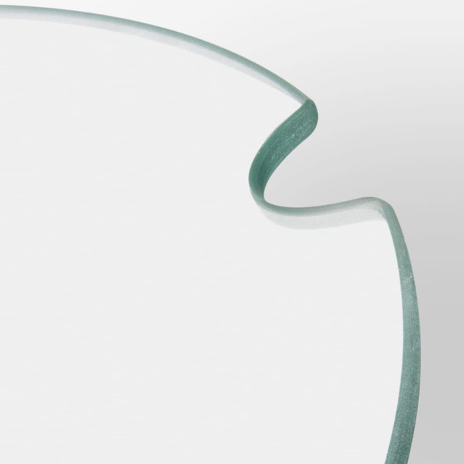 A transparent glass keepsake platter tray with a softly curved edge, featuring a subtle green tint.