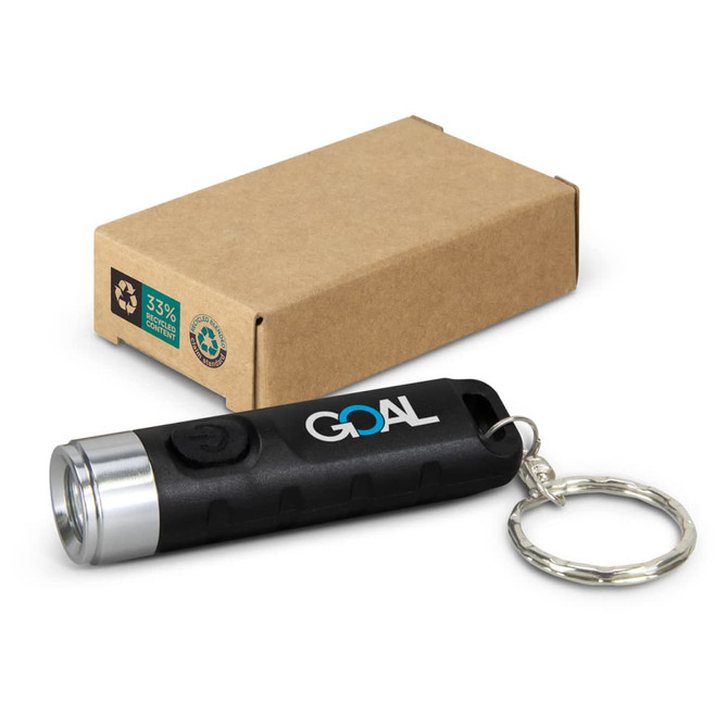 A black rechargeable torch keyring with a silver front and a keychain attached, next to a brown cardboard box.