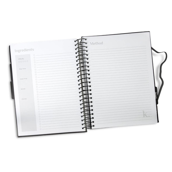 A black, spiral-bound recipe journal with blank pages for ingredients and method sections. It has a logo on the cover.