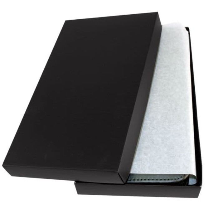 A black gift box partially open, revealing a leather travel wallet wrapped in protective paper.