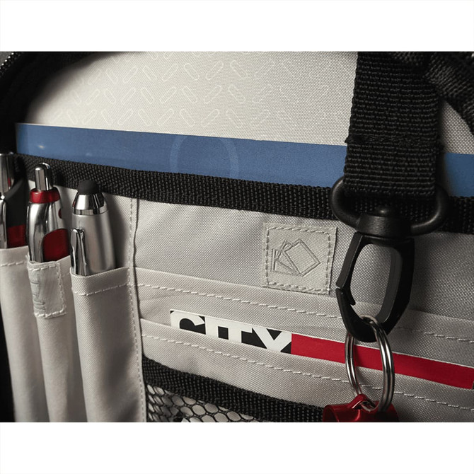 A grey backpack interior featuring pockets for pens, mesh storage, and a loop for attaching accessories.