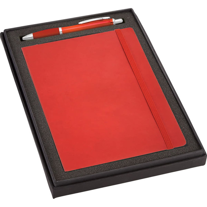 A red journal and orange pen packaged together in a black gift box with foam insert.