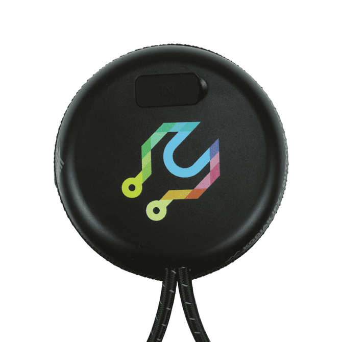 A round black Bluetooth speaker with a multicoloured logo, featuring a textured surface and a loop for attachment.