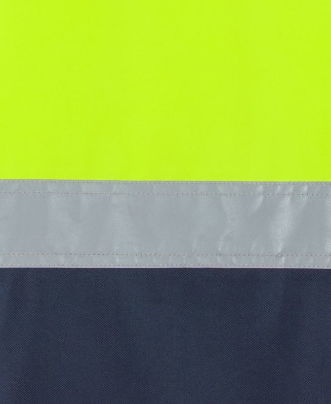 A close-up of a safety garment featuring bright lime and navy colours with reflective tape.