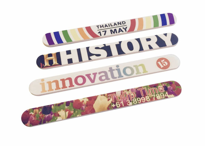 Four colourful nail files with various designs, including floral patterns and text. Each file features unique branding.