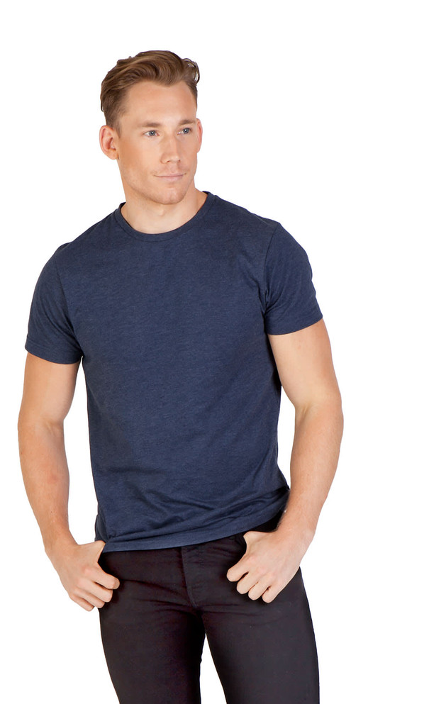 A navy crew neck T-shirt, made from marl fabric, displayed on a male model with casual black pants.