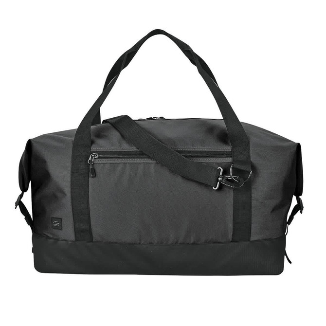 A black duffle bag with dual handles, a detachable shoulder strap, and a zippered front pocket. Features a logo.