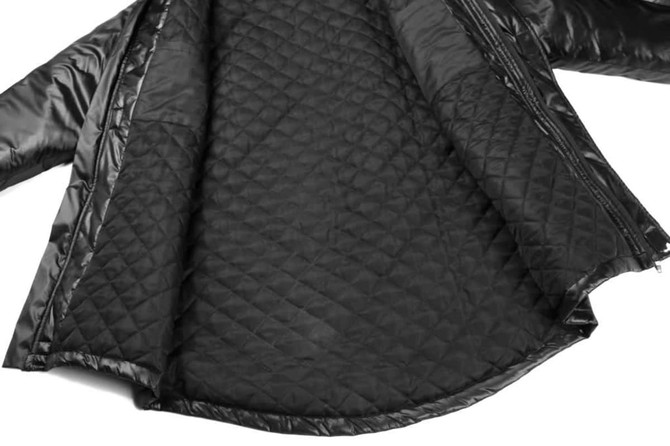 A black quilted manager coat jacket displaying its interior lining, featuring a smooth finish and a zip closure.