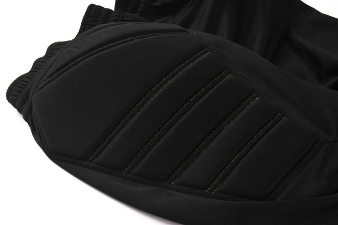 Black soccer goalkeeper pants featuring padded sections for added protection and a textured design.