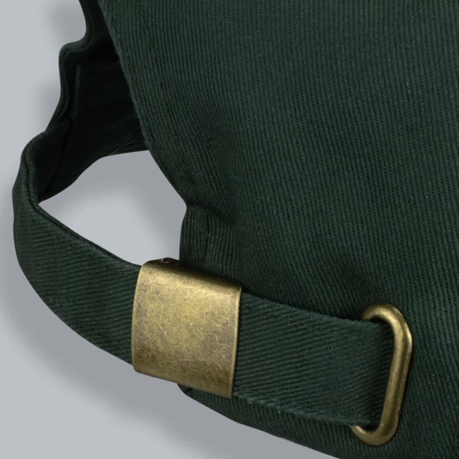 A green Outback Suede Peak Cap featuring a brass buckle and adjustment strap.