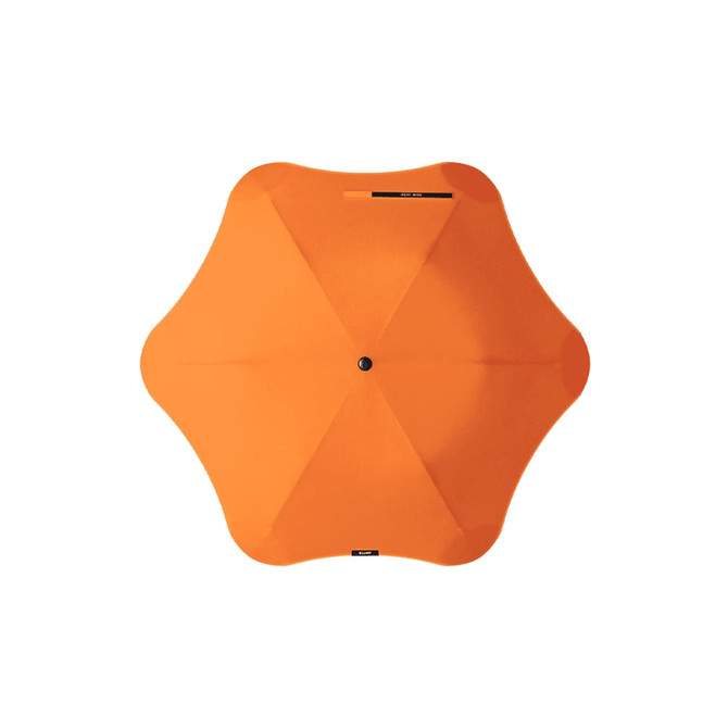 An orange BLUNT Metro Umbrella with a unique octagonal shape and central button for opening and closing.