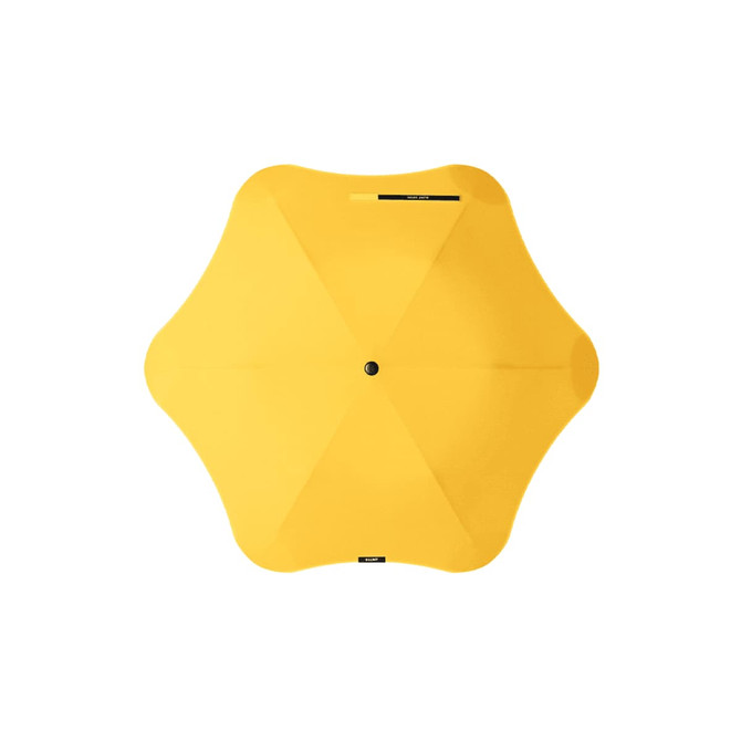 A yellow BLUNT Metro Umbrella with a distinctive design and a central button. It features a logo.