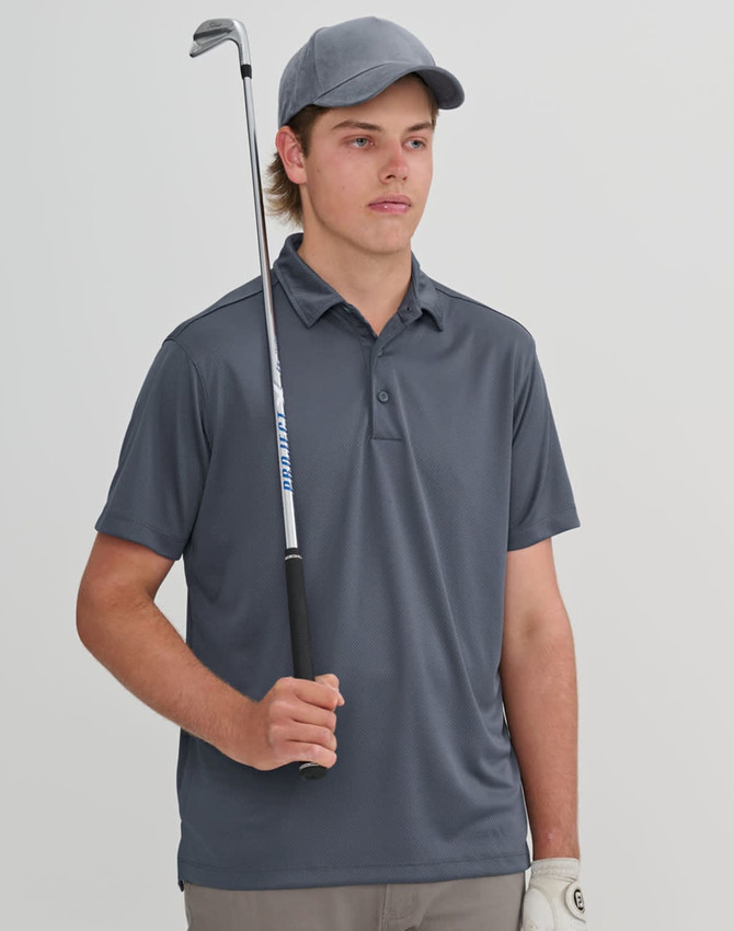 A young man holds a golf club while wearing a grey sustainable jacquard knit polo shirt and a matching cap.