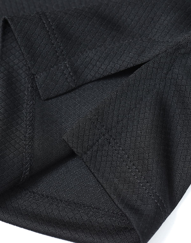A close-up of a black sustainable jacquard knit polo featuring textured fabric and detailed stitching.