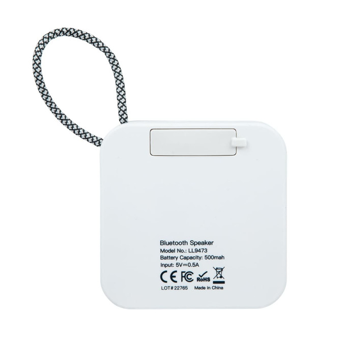A square white Bluetooth speaker with a hanging strap and a small compartment on the back for battery access.