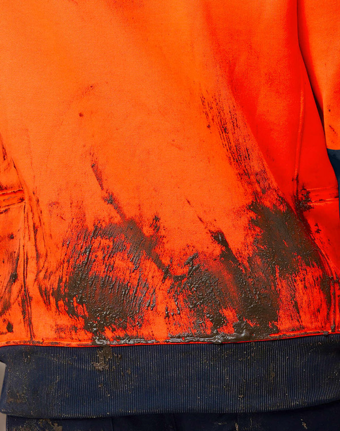 A Hi-Vis two-tone water-resistant fleece hoodie in orange, featuring a soiled fabric texture and a navy blue hem.