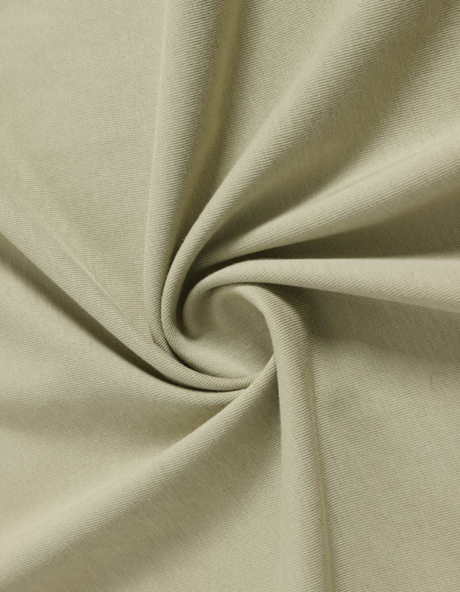 A close-up view of light beige fabric, showcasing its soft texture and smooth finish, suitable for a premium tee shirt.