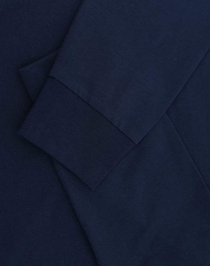 A navy blue long-sleeve T-shirt with folded sleeves and a subtle logo.