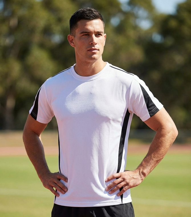 A man wearing a plain white t-shirt with black detail on the sides and short sleeves. It features a logo on the neck.