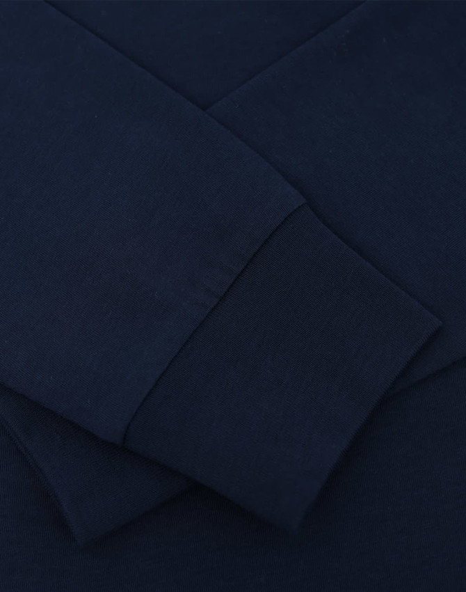 A navy blue long sleeve tee shirt featuring close-up details of the fabric and cuffs, with a logo present.