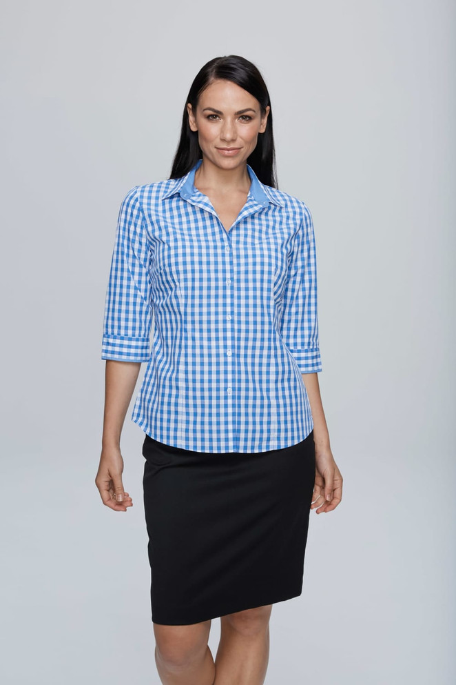 A blue and white check pattern 3/4 sleeve button-up shirt with a logo, paired with a black skirt.