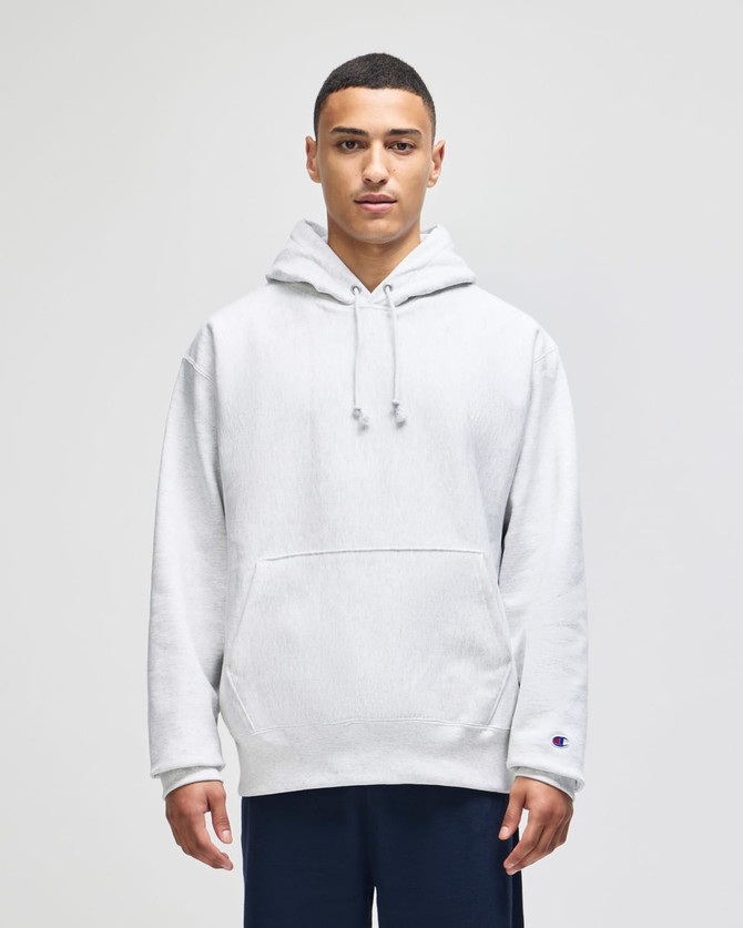 A grey pullover hooded sweatshirt with a front pocket and a logo on the sleeve.