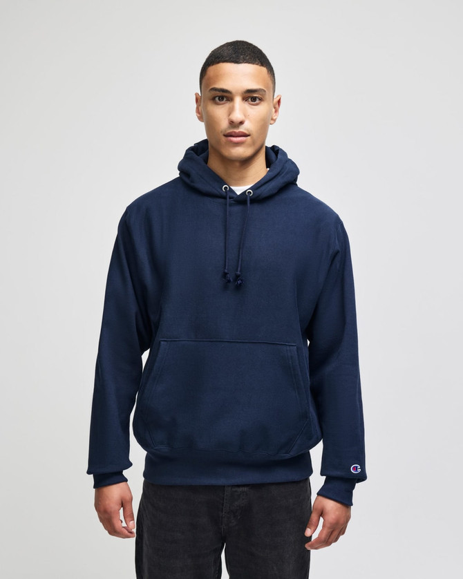 A navy blue Champion Reverse Weave® adult pullover hooded sweatshirt with a front pocket and hood.