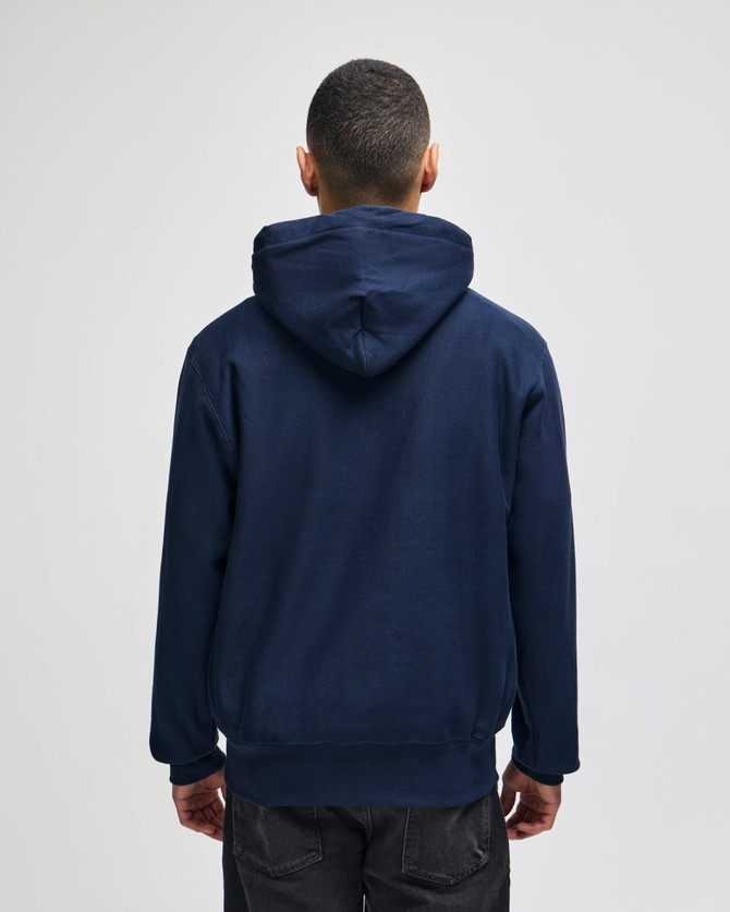 A navy blue pullover hooded sweatshirt with a logo on the back, featuring a relaxed fitting design.