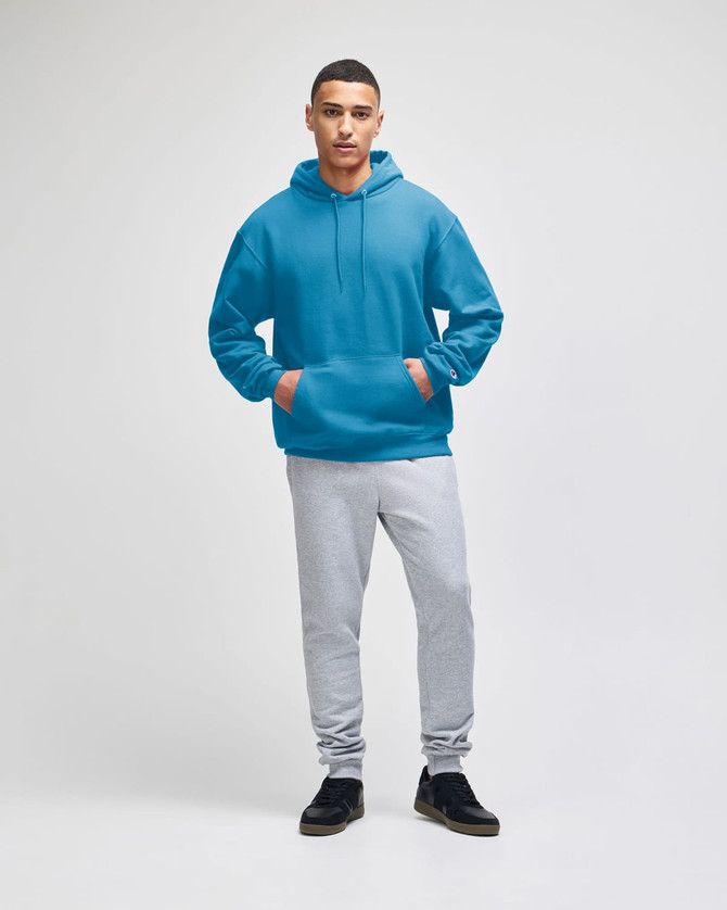 A blue pullover hooded sweatshirt worn with grey sweatpants, featuring a front pocket and a hood.