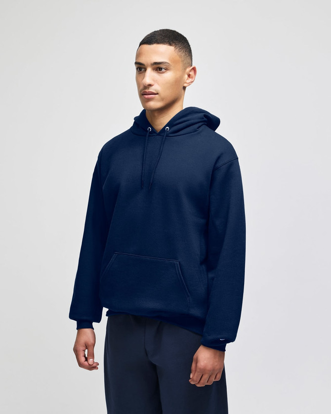 A navy blue pullover hooded sweatshirt with a front pocket and a logo, worn by a model.