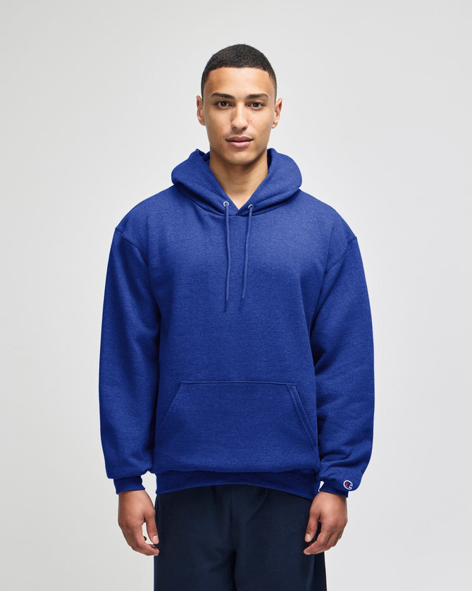 A blue pullover hooded sweatshirt on a model, featuring a spacious hood and a logo on the sleeve.