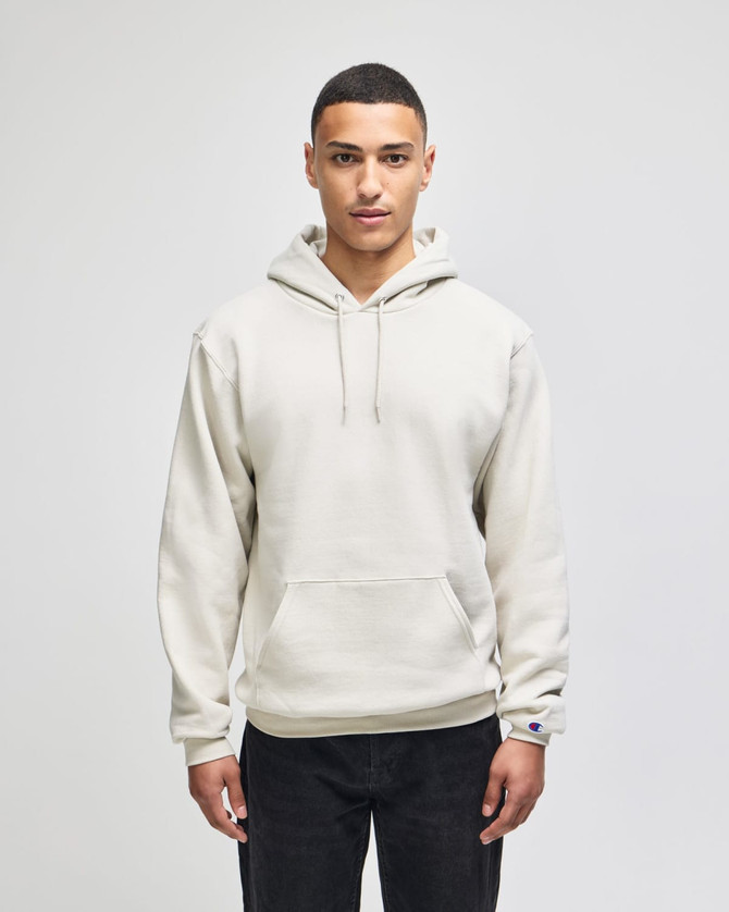 A light beige pullover hooded sweatshirt with a front pocket and a logo on the sleeve.