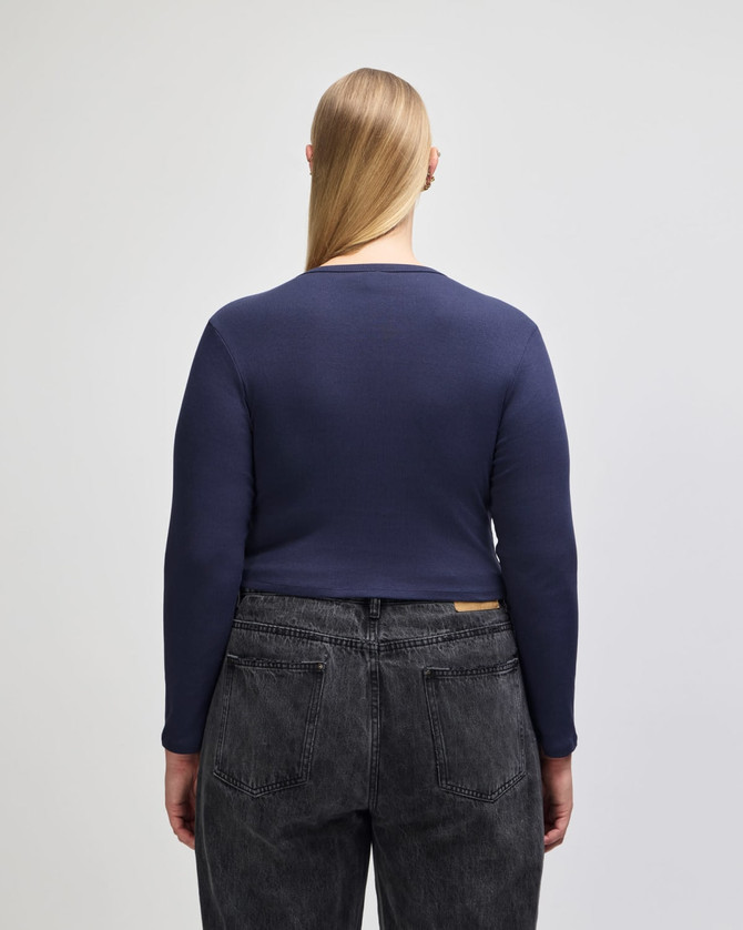 A navy blue long-sleeve fitted crop t-shirt with a crew neckline, viewed from the back.
