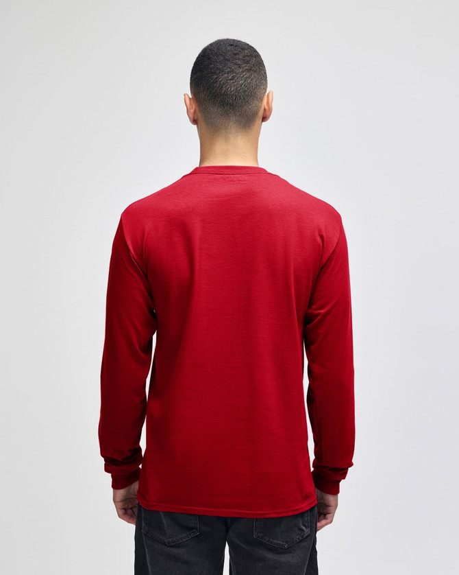 A red long-sleeve t-shirt from the back, featuring fitted sleeves and a simple design, with a logo visible.
