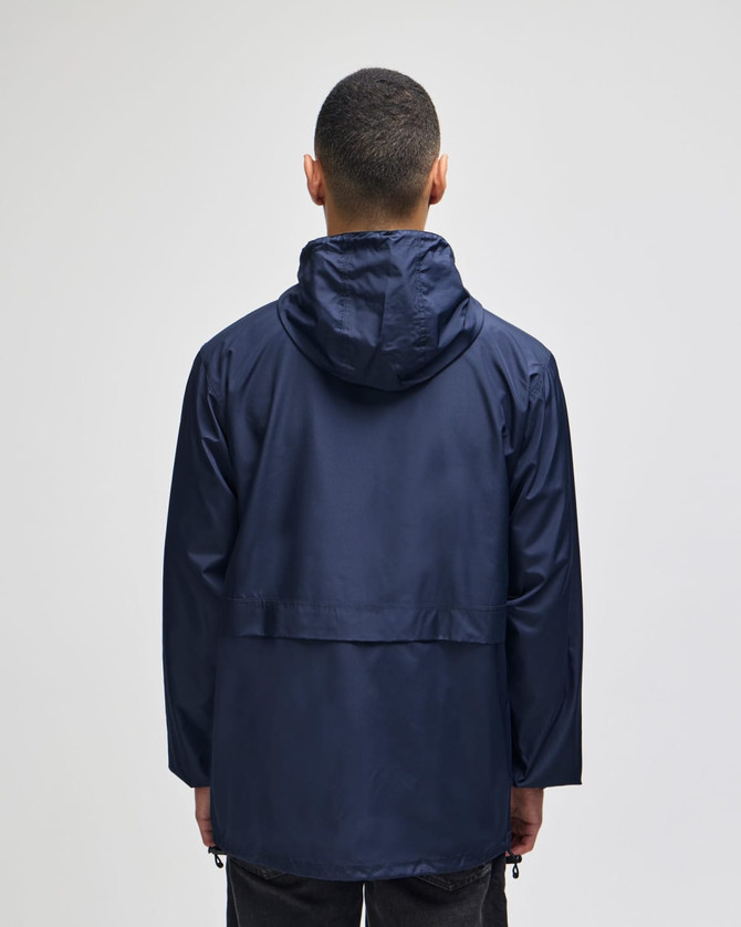 A navy full-zip anorak jacket with a hood and a back vent, featuring a logo.