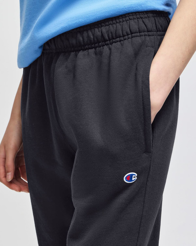 A pair of black fleece joggers with an elastic waistband, featuring a logo on the side pocket.