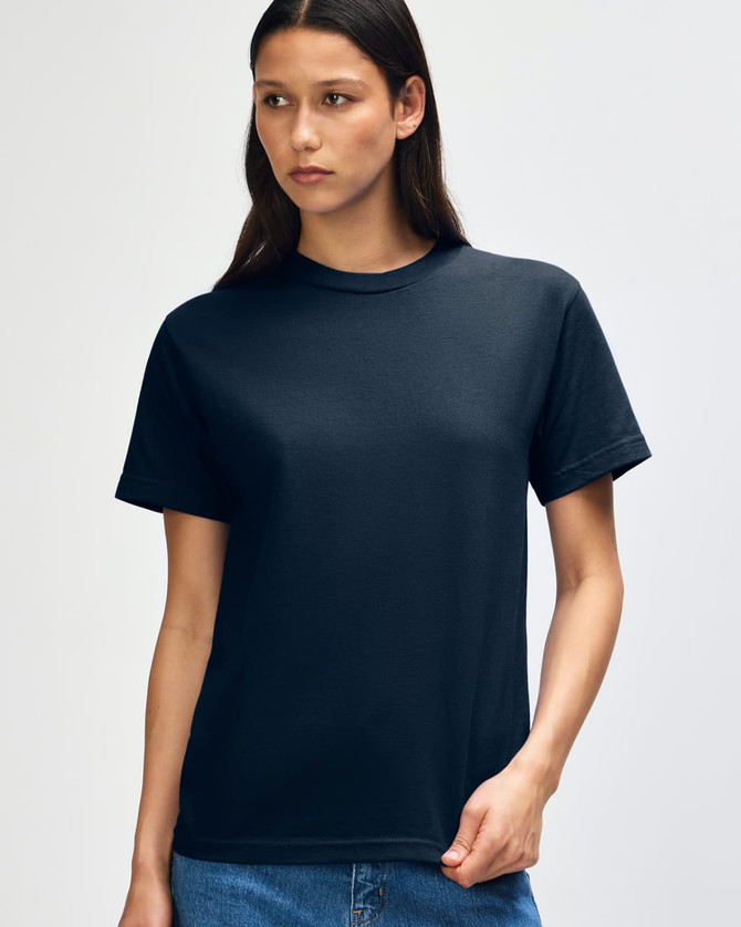 A heavyweight cotton unisex t-shirt in black, displayed on a model. The shirt has a simple design and a logo.