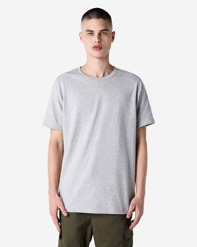 A heavyweight cotton unisex T-shirt in grey, featuring short sleeves and a relaxed fit. It has a logo on it.