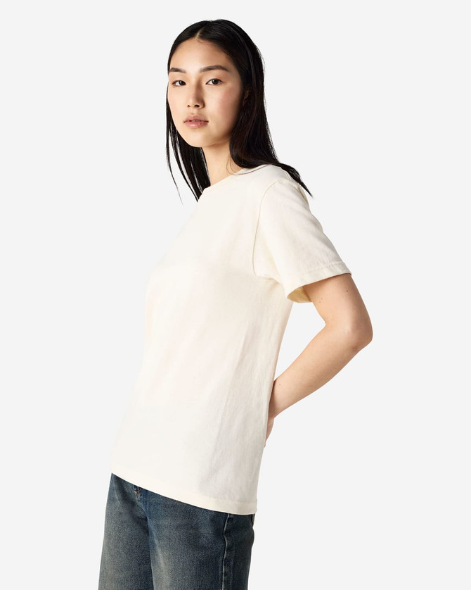 A heavyweight cotton unisex t-shirt in cream, displayed on a model with a neutral background.