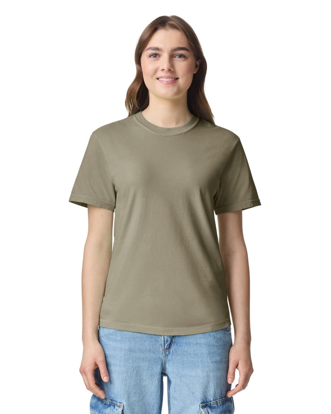 A woman wearing a short-sleeved, heavyweight t-shirt in olive green with a logo on the chest.