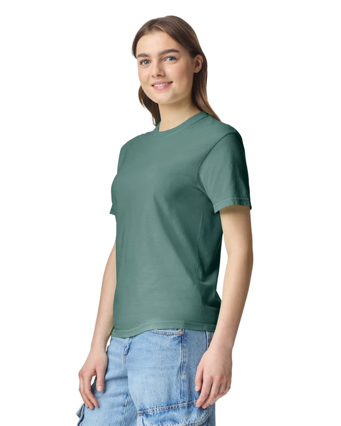 A green heavyweight t-shirt is displayed on a model, featuring a casual fit and a simple design.