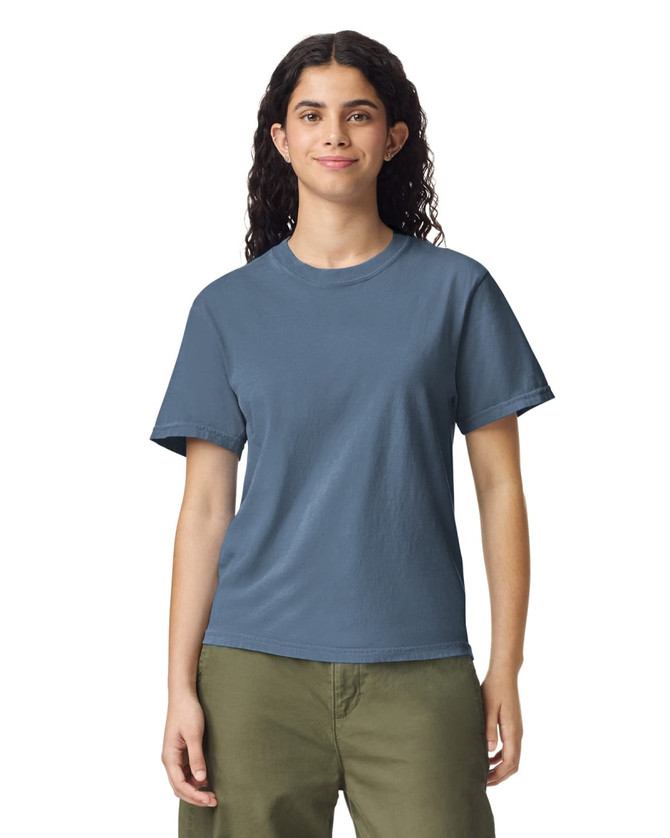 A blue heavyweight t-shirt on a model, featuring a round neckline and short sleeves. The shirt has a logo.