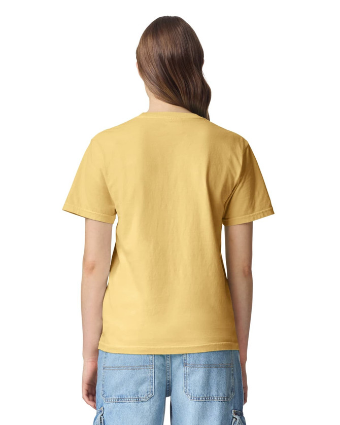 A yellow heavyweight T-shirt featuring a plain back design. The model is wearing casual blue denim shorts.