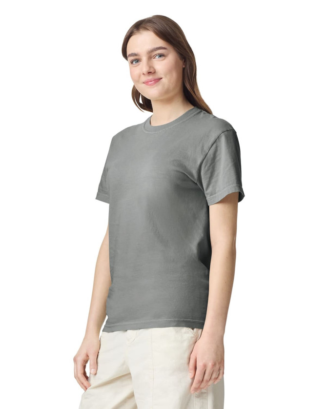 A grey adult heavyweight T-shirt displayed on a model, featuring a simple design and a crew neckline.