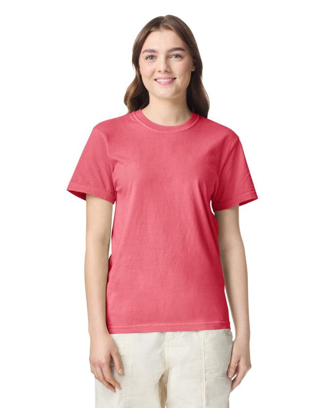 A pink adult heavyweight T-shirt displayed on a model, featuring short sleeves and a round neckline.