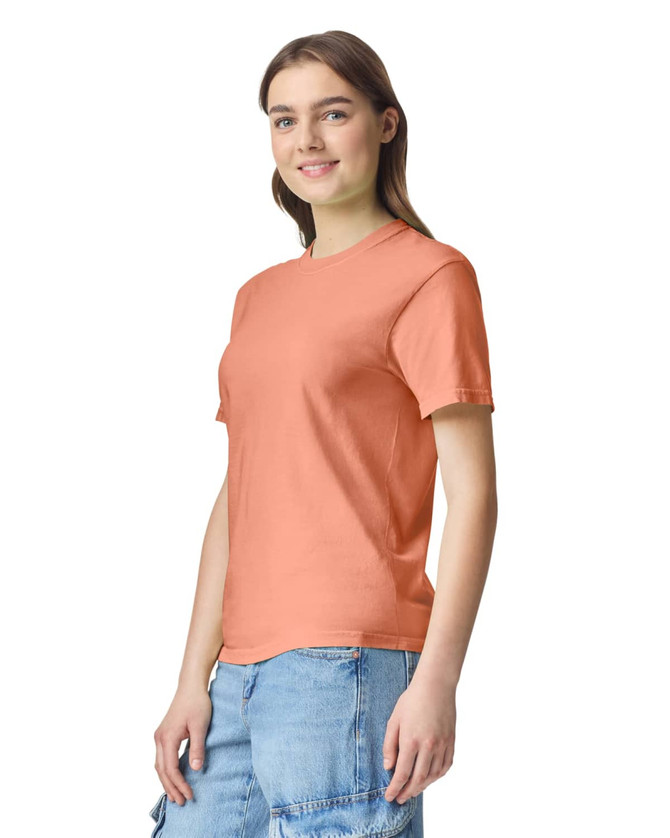 A peach heavyweight T-shirt featuring a round neck and short sleeves, displayed on a model.