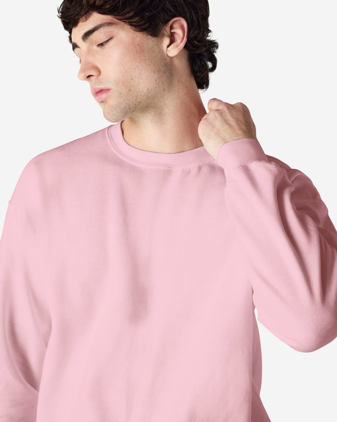 A pink Gildan Heavy Blend adult crewneck sweatshirt featuring long sleeves and a relaxed fit.