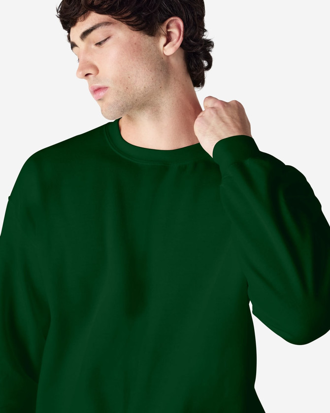 A green crewneck sweatshirt worn by a person, featuring a logo on the sleeve.
