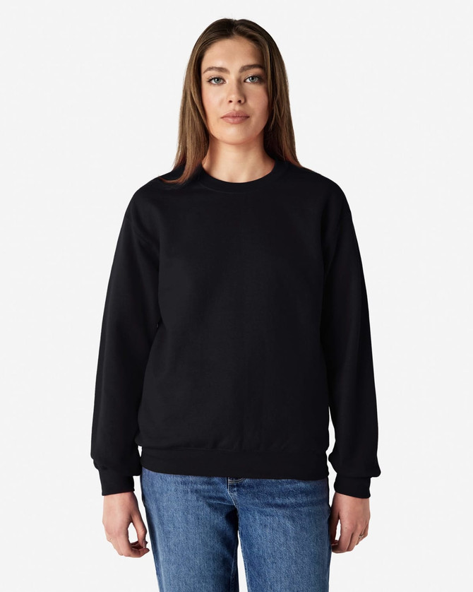 A black Gildan Heavy Blend adult crewneck sweatshirt displayed on a model wearing blue jeans.